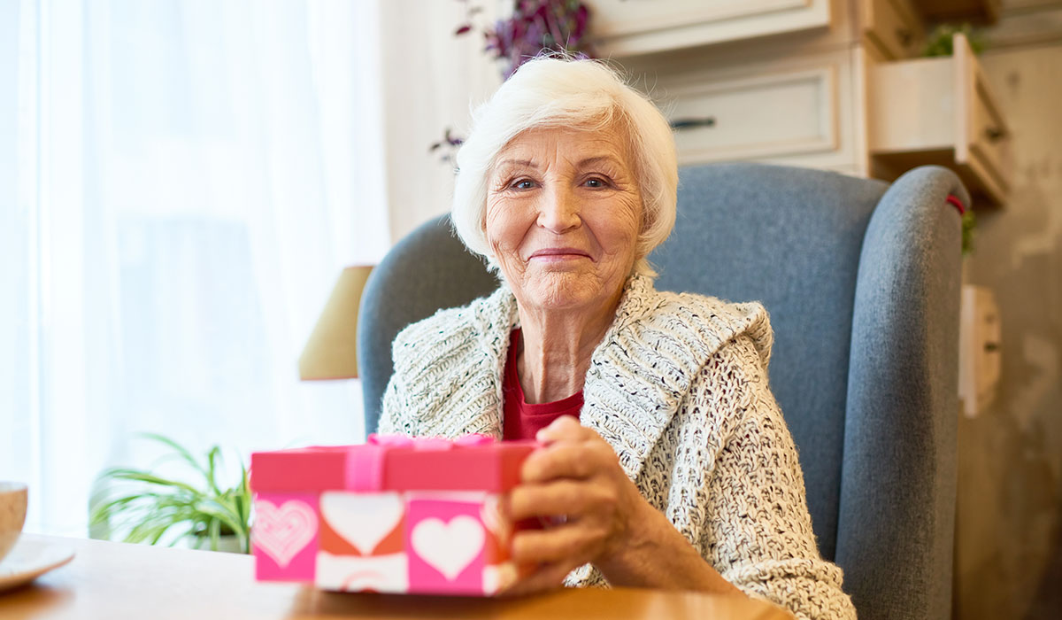 elderly woman with christmas gift