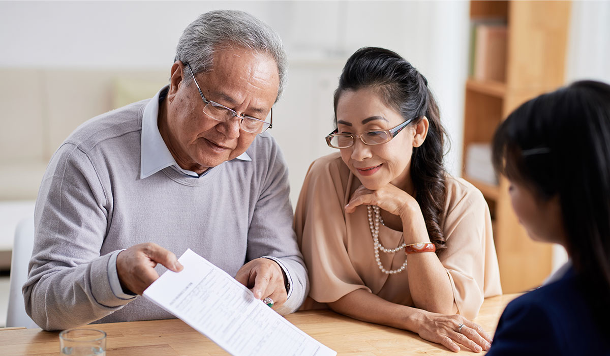 senior couple looking at estate contract