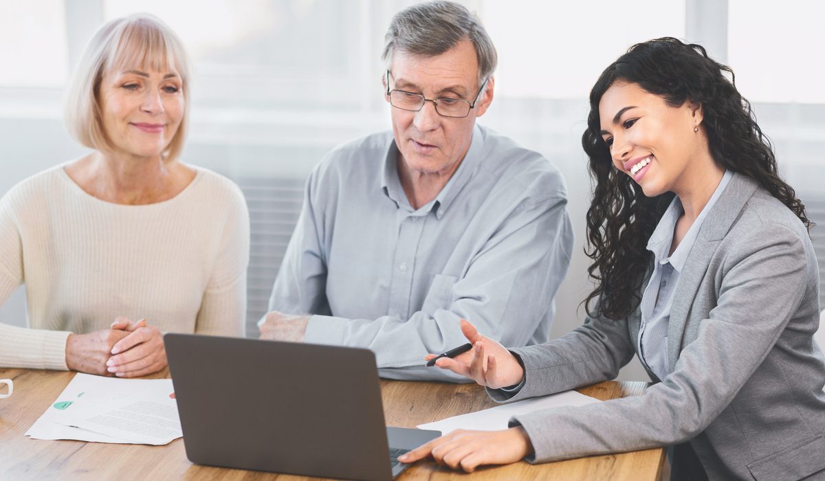 Elderly couple consulting with Attorney at home