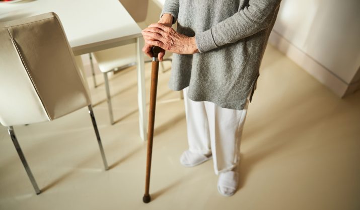 elder woman using a cane